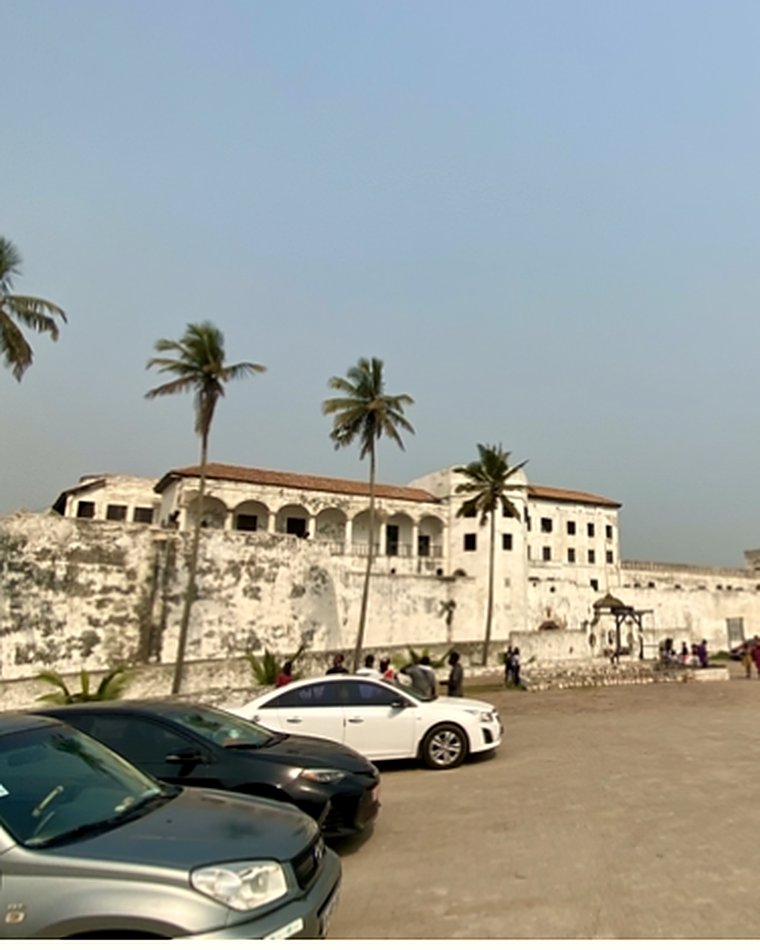 Elmina Castle behind palm trees on the Ghanaian coast