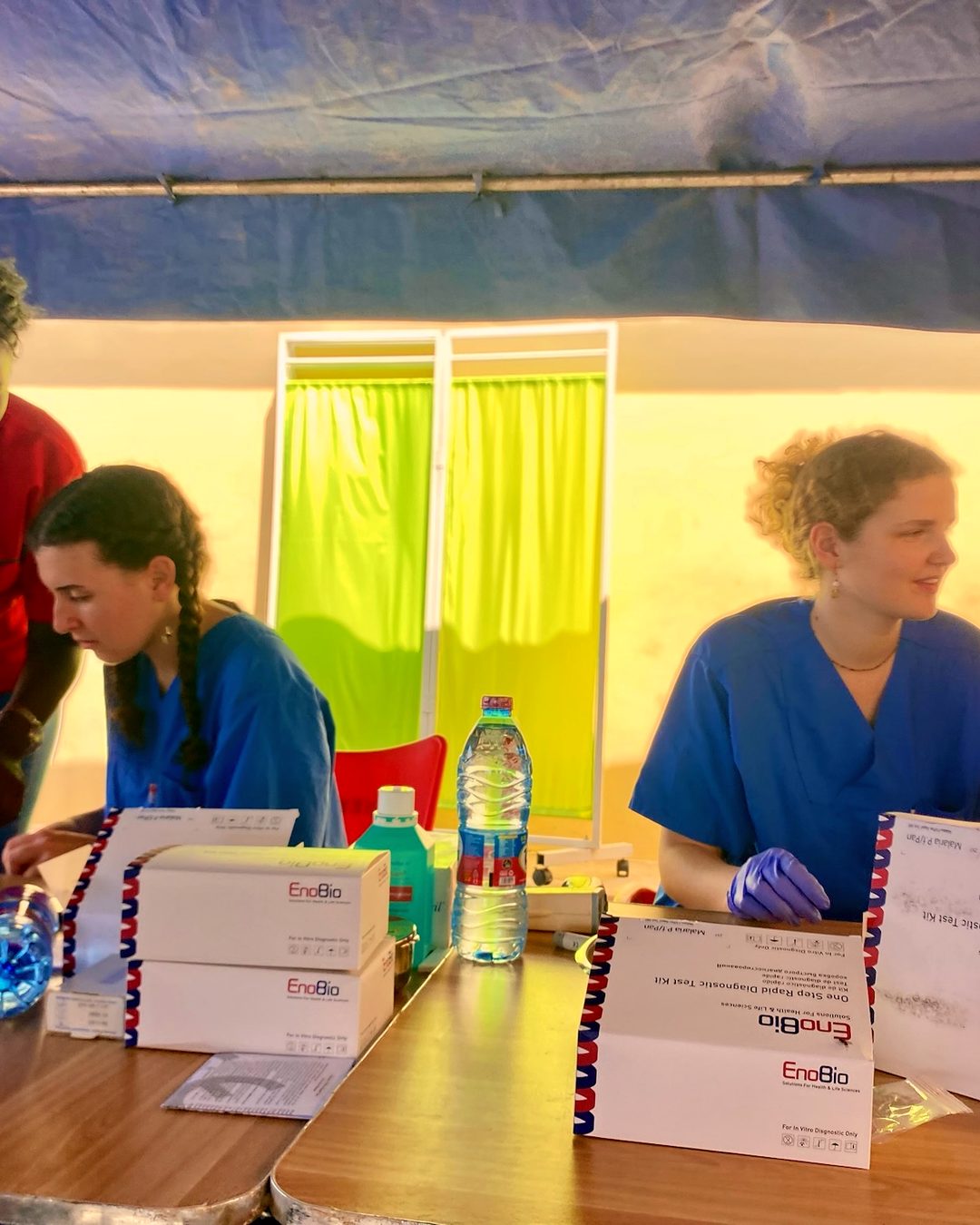 A health screening underway during an outreach day, with the team and community members together